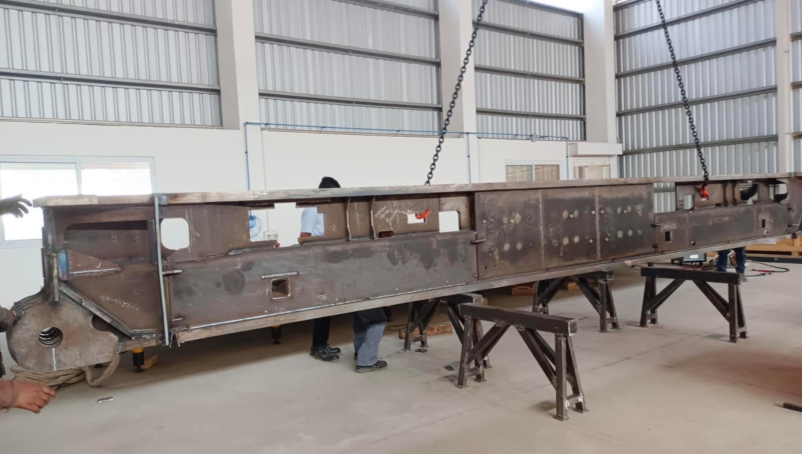 Long fabricated steel beam supported on trestles in the workshop