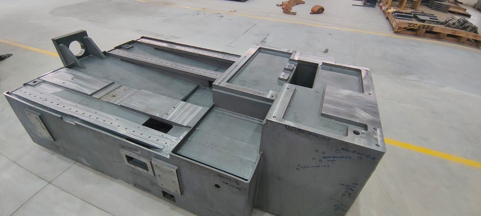 Heavy machine base weldment with machined mounting faces