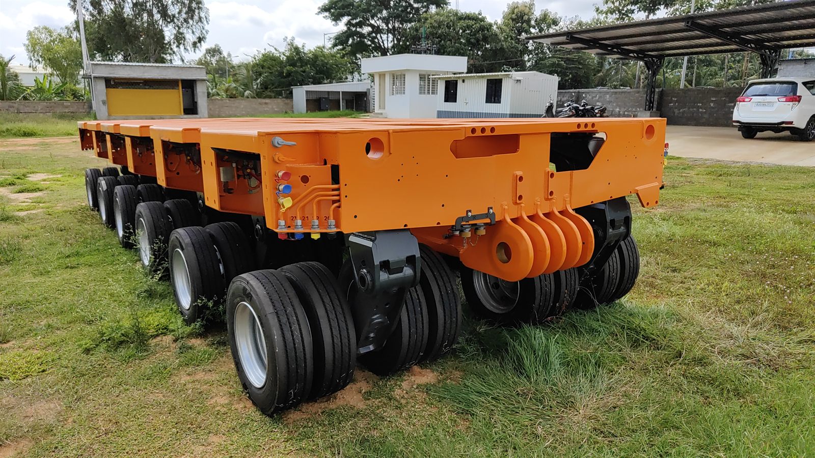 Multi-axle modular hydraulic trailer showing suspension and couplings